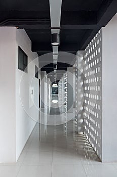 Long modern hotel corridor with sunlight through the wall