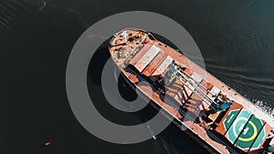 Long modern vessel with brown deck sails on endless ocean