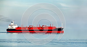 Long oil and gas petrochemical tanker offshore in opensea with 3 red tanks for liquefied gas.