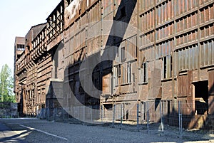 Long old rusty factory hall before reconstruction