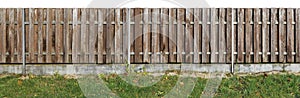 Long old solid aged brown wooden rural fence from vertical pi photo
