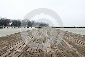 Long old wooden dock on the lake