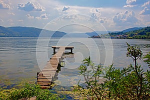 Long old worn woon scaffolding along Danube river with hazy mountains in the background