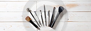 Long panorama for display of professional makeup brushes over wood