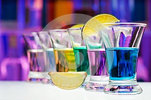 Long perspective row of shots with color drinks