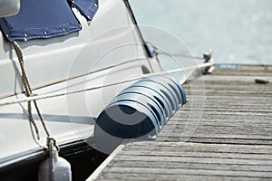 Long pier blue fenders for a boat and dockside for protection. Maritime fenders