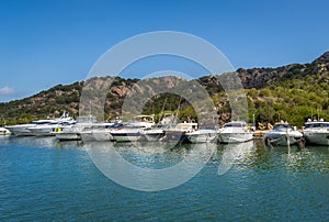 Long pier with recreational fleet boats. Poltu Quatu resort marina, Sardinia.