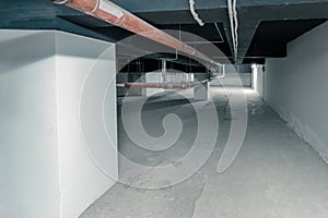 an long pipe in a technical room in the basement of a large building