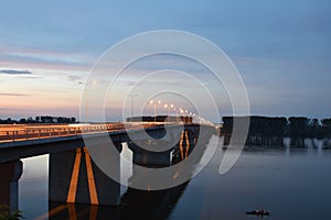 Long Pupin Bridge over the Danube illuminated by orange light from artificial lighting