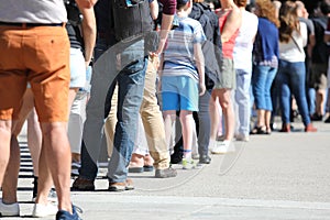 Long queue of people waiting in line