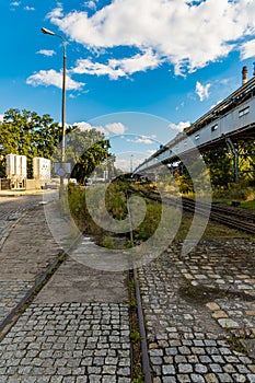 Long rails at old unused factory square next to bridge