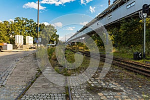 Long rails at old unused factory square next to bridge