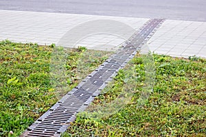 Long Rain drain on grass and pavement