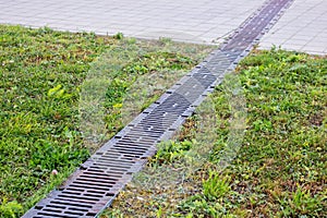 Long Rain drain on grass and pavement