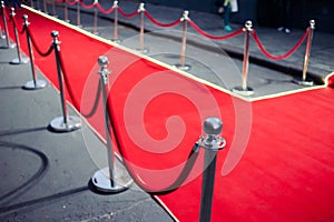 Long red carpet between rope barriers on entrance.