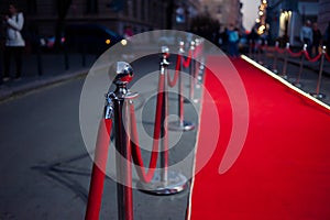 Long red carpet between rope barriers on entrance.