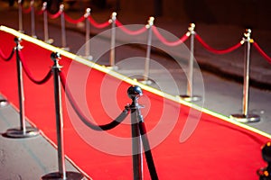 Long red carpet between rope barriers on entrance.