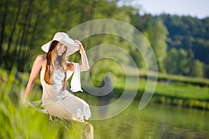 Long red hair romantic woman relax by lake