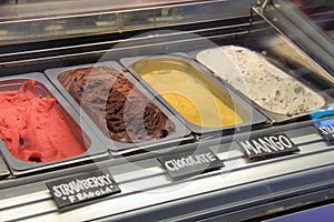 Long, refrigerated case filled with varieties of gelato