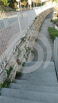 Long retaing wall below village road