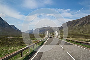 A Long Road to a bridge with beautiful mountain and hills view in highland amazing landscape.