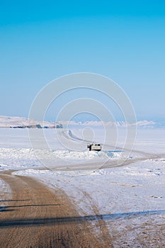 A long road to a frozen lake.