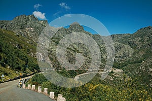 Long roadway passing through rocky landscape