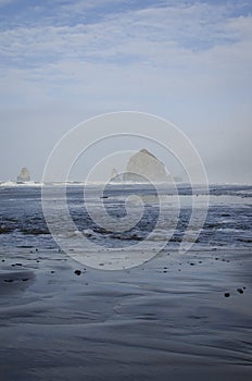 The long rock formation out in the ocean