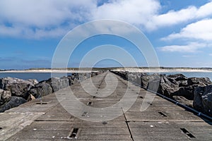 Long rocky and concrete storm groin jetty to protect against erosion on the Wadden Sea coast of western Denmark