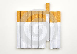 Long row of cigarettes with orange filter tips