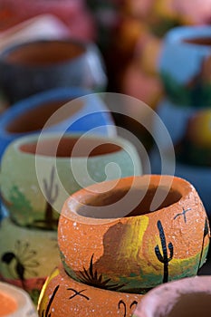 Long row of colorful ceramic pots in pottery workshop