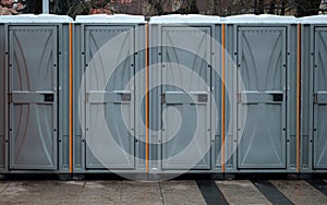 Long row of mobile toilets outside in the city. Bio toilets outdoors