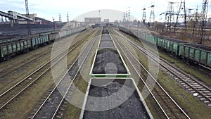 Long row of train cargo cars loaded full with fossil fuel coal.