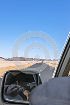Long Sahara road trip in empty reg and sandy desert.