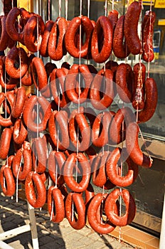 Long sausages hanging in bunches.