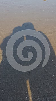 Long Shadow of a couple on the beach