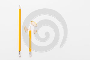 Long and short pencils with shavings on white