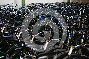 Long shot of many bicycle handlebars in a warehouse