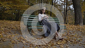Long shot shot. Stylization under the thirties Black-haired woman in a beret and a long skirt. against the backdrop of