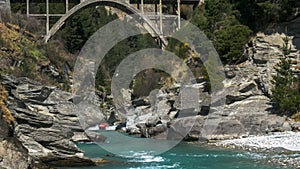 Long shot of the shotover jet and the hstoric edith cavell bridge