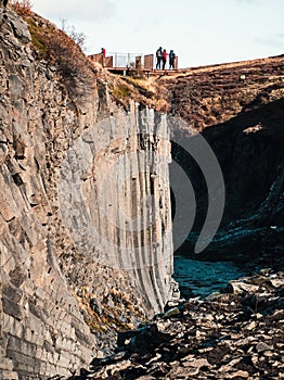 Viewpoint with tourists over basaltic columns and river canyon