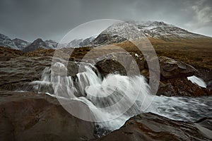 Long silky waterfall between stones and rocks. travel, tourism, adventure, mountaineer concept- Fairy Pools - Skye Island -