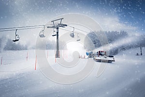 Long ski lift line and the working snow cannon on Austrian Alps