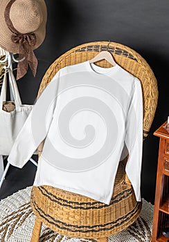 A long sleeve shirt hanged on to a chair with minimalistic decorations