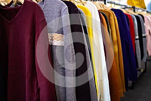 Long sleeved t-shirt many colours hanging on the rack,comfortable clothes and cheap,variety of popular fashion clothes in asian