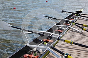 Long sport boat with oars stands