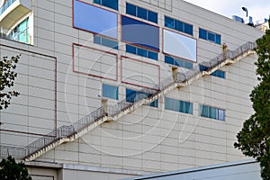 Long staircase connects the emergency exits of all floors on the outer wall of a large shopping and entertainment center