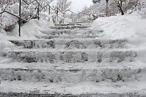 Long stairs covered with a layer of Snow. Watch out for ice.
