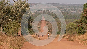 Long straight dirt road in open African landscape