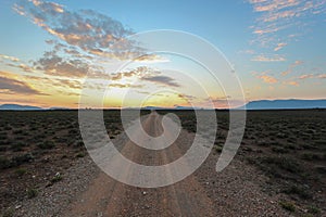 Long straight dirt road at sunset in Camdeboo National Park